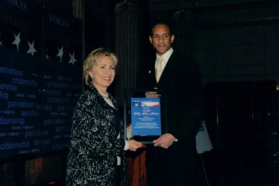 Wilfred Stephen Anfield serves as Master of Ceremonies and presents the Edward M. Kennedy National Service Lifetime Leadership Award to Senator Hillary Rodham Clinton at the bipartisan Friends of National Service Awards in Washington, D.C., 2007, hosted by Voices for National Service.